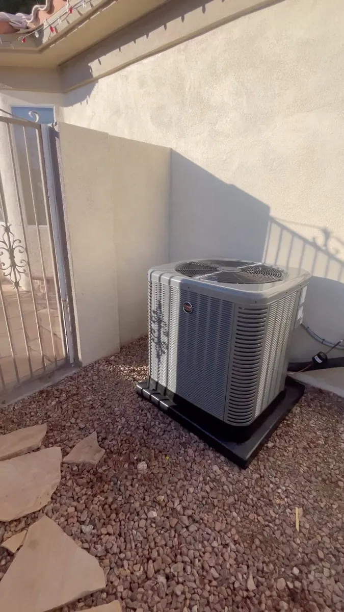 Air conditioning condenser installed by Freeze Zone at a Las Vegas home, set on desert gravel against stucco